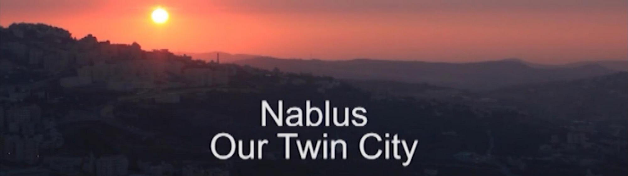 Sunset over Nablus with title Nablus is our twin city